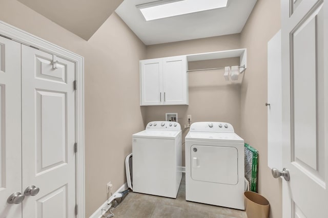 laundry area featuring cabinet space, independent washer and dryer, and baseboards