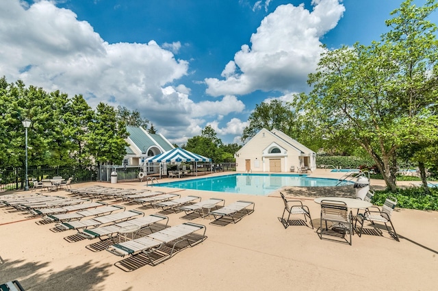 community pool featuring a patio area and fence