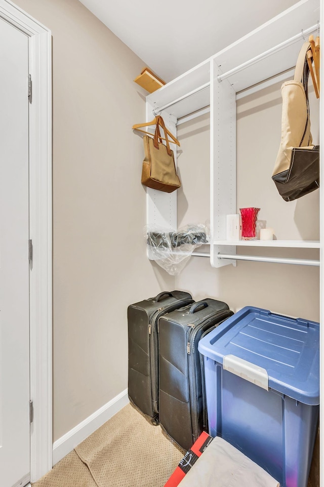 washroom featuring washing machine and dryer, laundry area, and baseboards