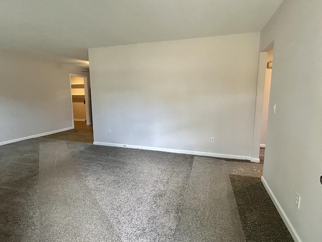 empty room with carpet and baseboards