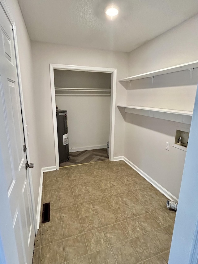 walk in closet featuring water heater