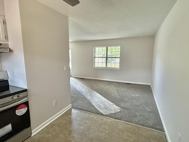 empty room featuring carpet flooring and baseboards