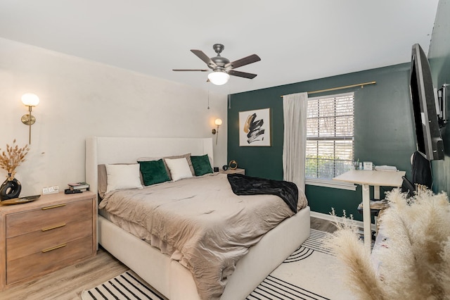 bedroom featuring light wood-type flooring and ceiling fan