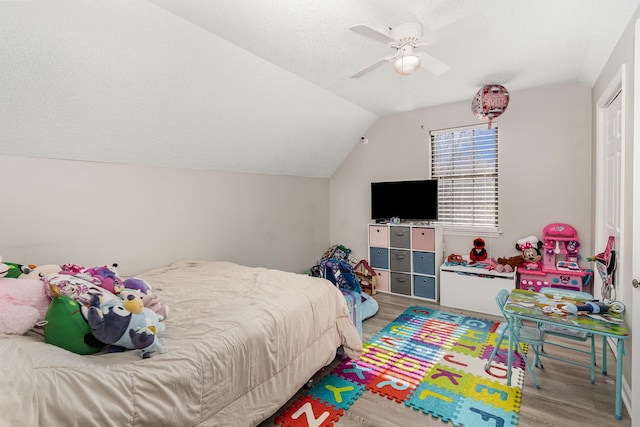 bedroom featuring lofted ceiling, ceiling fan, and wood finished floors