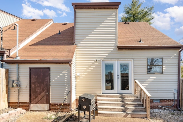 back of property featuring entry steps, crawl space, a shingled roof, and french doors