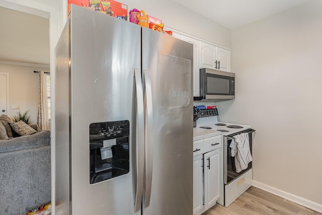 kitchen with light countertops, appliances with stainless steel finishes, light wood-style floors, white cabinetry, and baseboards