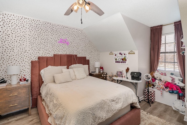 bedroom with vaulted ceiling, ceiling fan, and wood finished floors