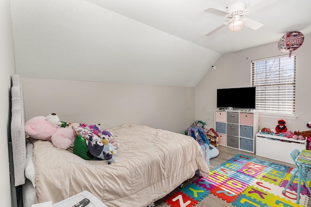 bedroom with lofted ceiling, ceiling fan, and light wood finished floors