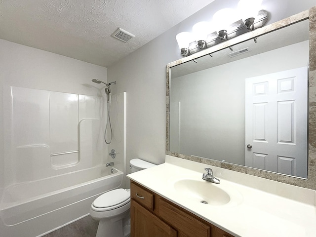 full bathroom featuring visible vents, a textured ceiling, toilet, and vanity