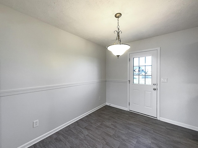 interior space featuring baseboards and a textured ceiling