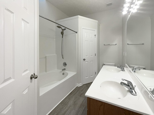 bathroom featuring double vanity, visible vents, and a sink