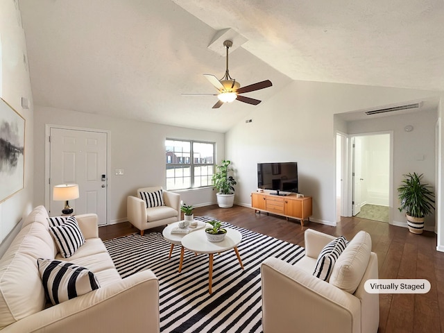 living room featuring lofted ceiling, ceiling fan, wood finished floors, visible vents, and baseboards