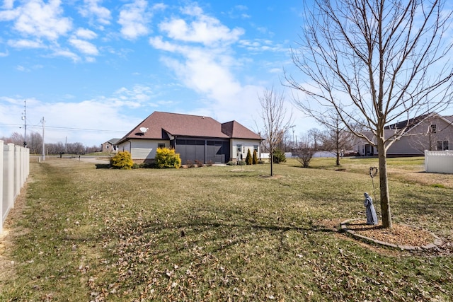 view of yard featuring a sunroom and fence