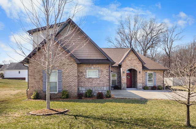 view of front of home with brick siding, a front yard, fence, and a shingled roof