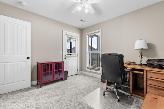 home office with ceiling fan, carpet floors, visible vents, and baseboards