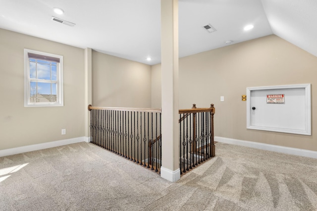 interior space with carpet floors, baseboards, and visible vents