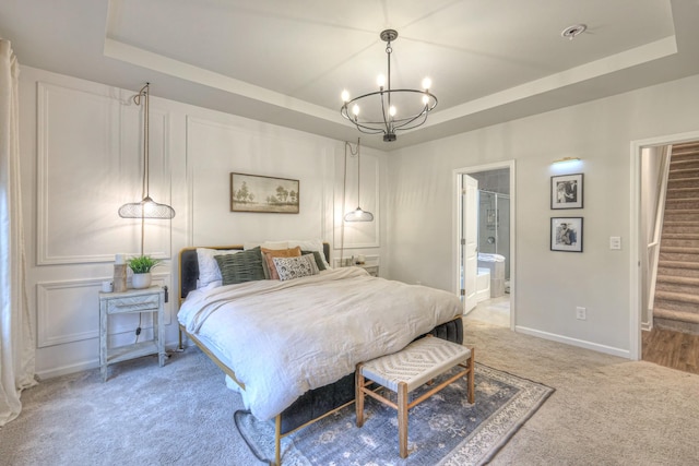 bedroom featuring baseboards, a chandelier, a raised ceiling, and light colored carpet