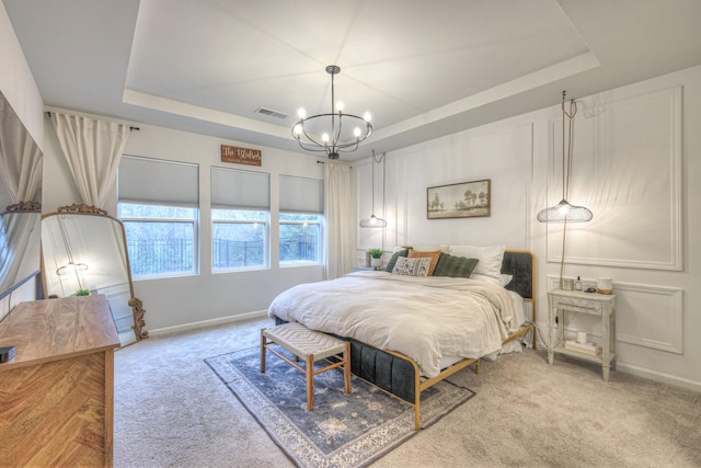 bedroom with carpet, a raised ceiling, visible vents, and a notable chandelier