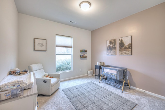 sitting room with light carpet, visible vents, and baseboards