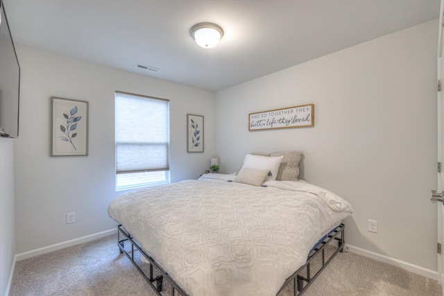 bedroom with carpet floors, visible vents, and baseboards