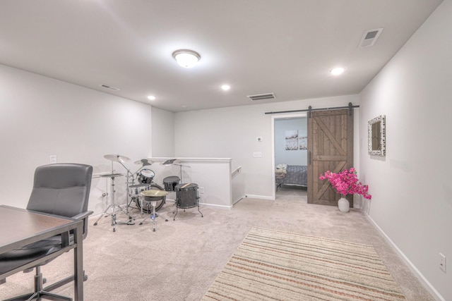 home office featuring carpet, a barn door, visible vents, and baseboards