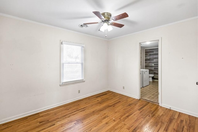 spare room featuring ceiling fan, ornamental molding, wood finished floors, and baseboards