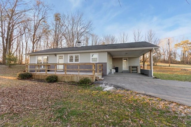 view of front of house featuring a carport, driveway, and a deck