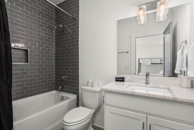 bathroom featuring toilet, vanity, and bathing tub / shower combination