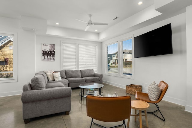 living room with concrete floors, recessed lighting, and baseboards