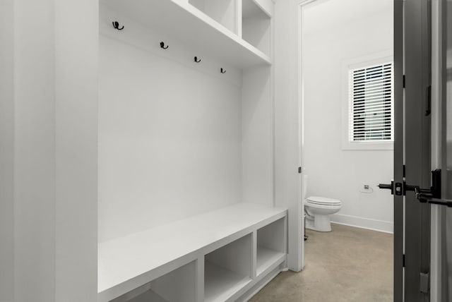 mudroom featuring concrete floors and baseboards