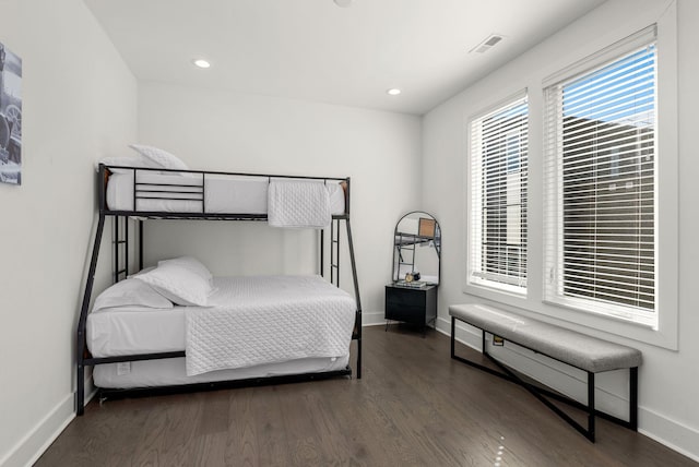 bedroom featuring baseboards, visible vents, wood finished floors, and recessed lighting