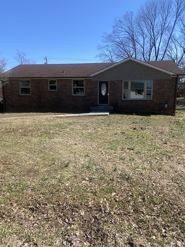 ranch-style house with brick siding and a front lawn