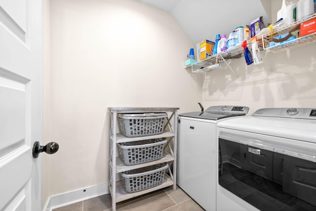 laundry room featuring laundry area, washing machine and dryer, baseboards, and light tile patterned flooring