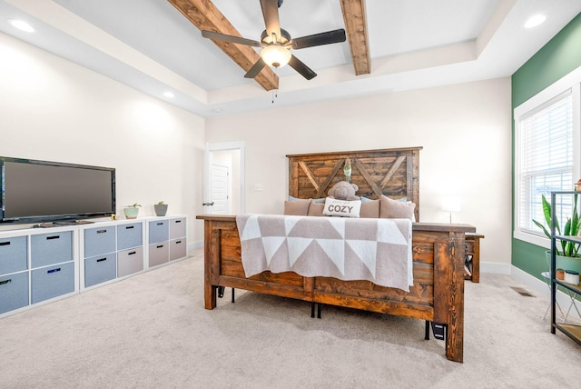 bedroom with beam ceiling, recessed lighting, a raised ceiling, light colored carpet, and baseboards