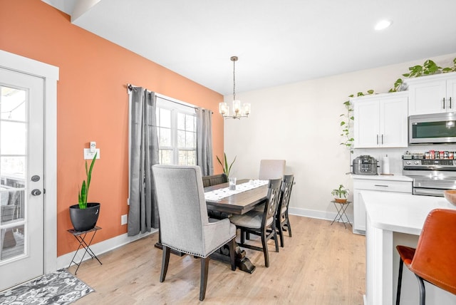 dining room featuring recessed lighting, baseboards, a notable chandelier, and light wood finished floors