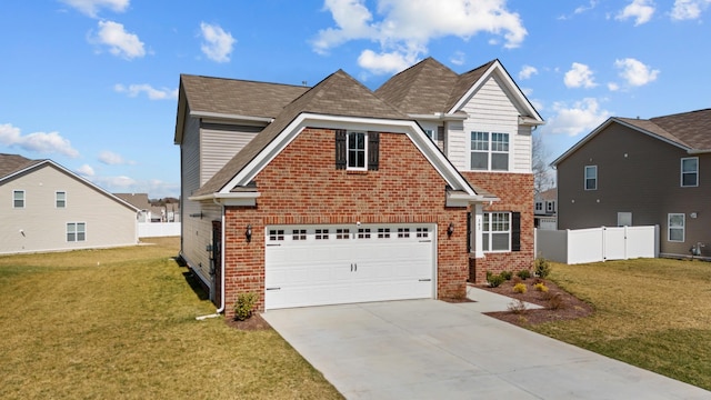 traditional home with driveway, an attached garage, fence, a front lawn, and brick siding