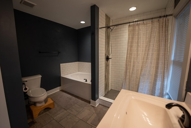 full bathroom featuring visible vents, toilet, a shower stall, baseboards, and a bath