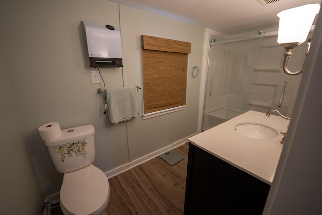 full bath featuring visible vents, toilet, wood finished floors, an enclosed shower, and vanity