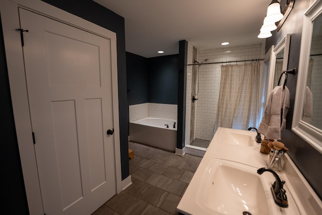 bathroom with a garden tub, double vanity, a sink, and a shower stall