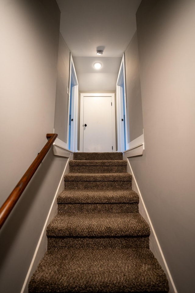 stairway featuring baseboards