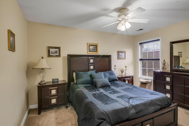 bedroom featuring light carpet, baseboards, and a ceiling fan