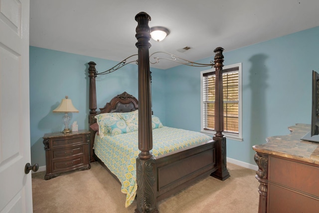 bedroom featuring light carpet, visible vents, and baseboards