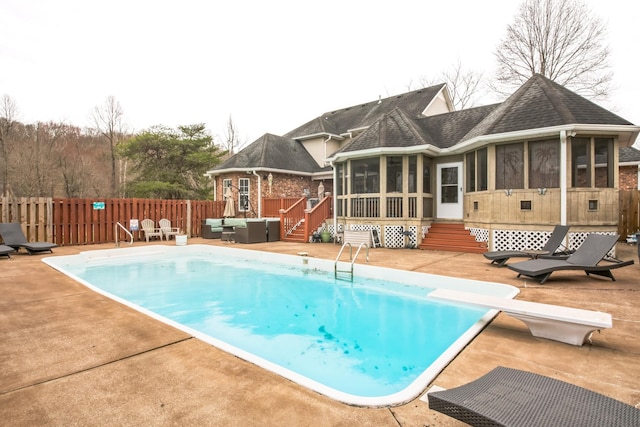 view of pool featuring a fenced in pool, a sunroom, fence, a patio area, and an outdoor living space