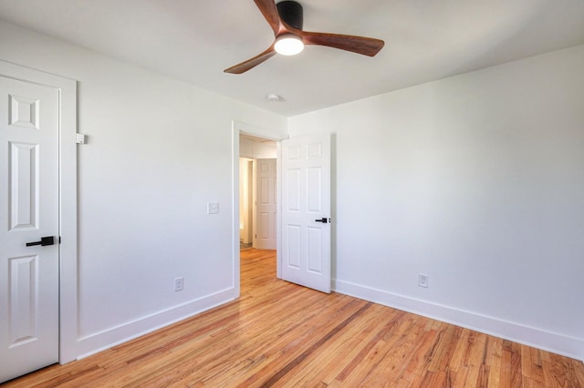 unfurnished bedroom featuring ceiling fan, light wood finished floors, and baseboards