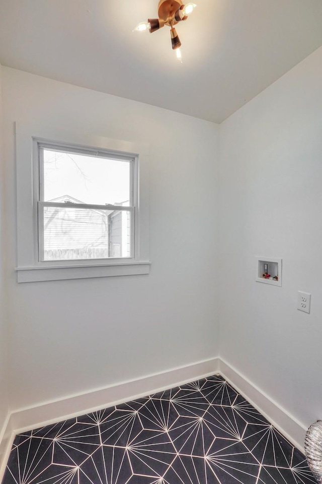 clothes washing area featuring washer hookup, laundry area, and baseboards