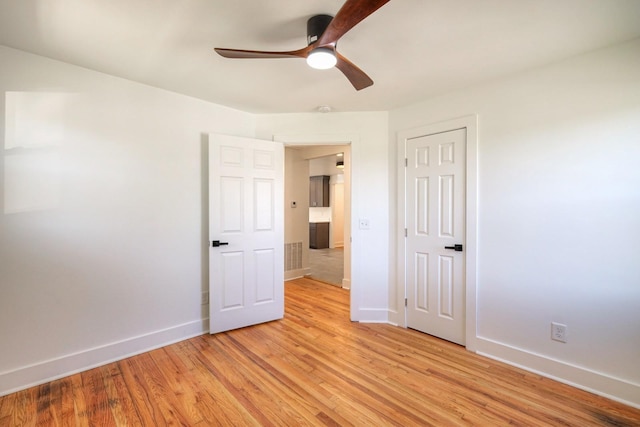 unfurnished bedroom with visible vents, a ceiling fan, light wood-style flooring, and baseboards