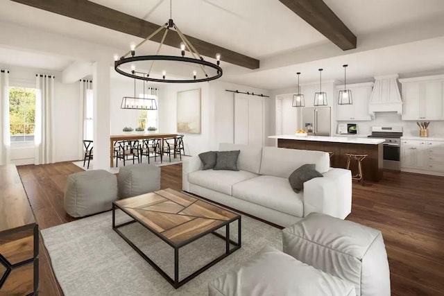 living area with dark wood-type flooring, a notable chandelier, beamed ceiling, and a barn door