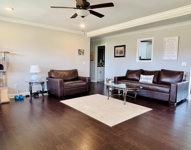 living room with baseboards, ceiling fan, ornamental molding, and wood finished floors