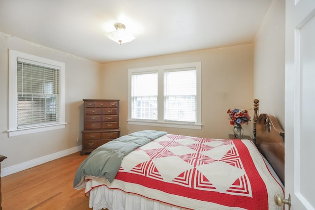 bedroom with baseboards and wood finished floors