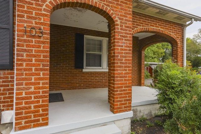 property entrance featuring brick siding